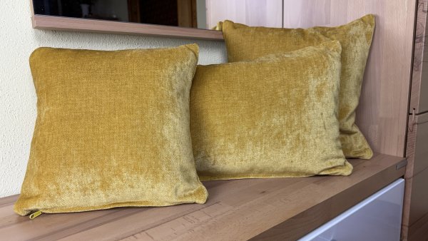 Dekokissen Chenille gelb auf Bank